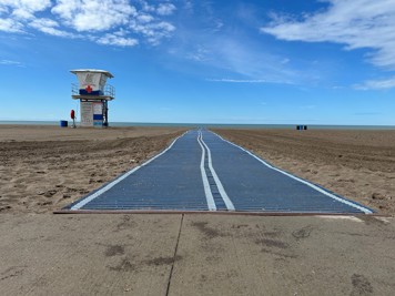 Blue mat laying across the sand at Port Stanley Main Beach